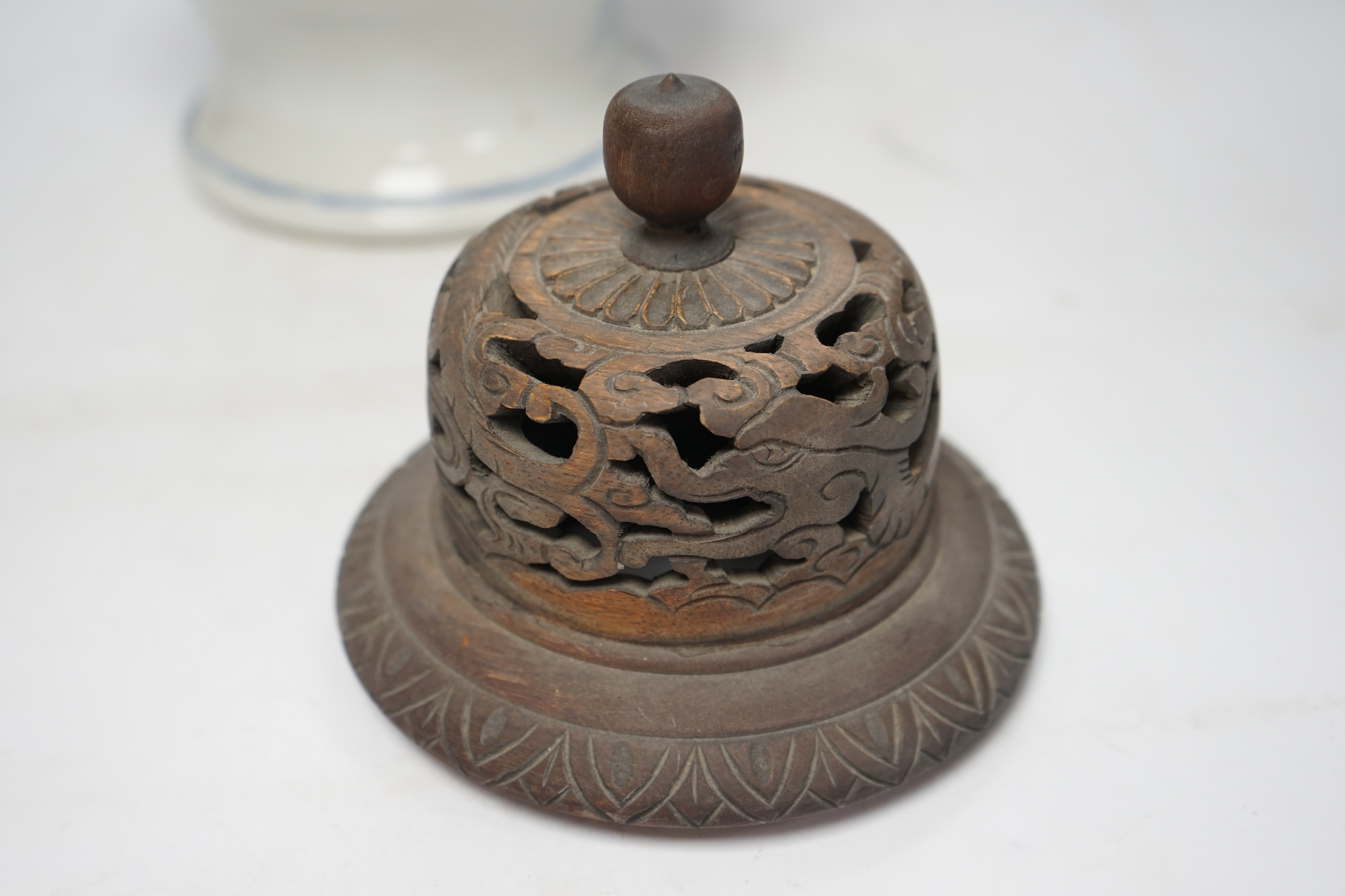 A 19th century Chinese blue and white baluster jar, painted with a dignitary and attendants at a table with objects in a garden setting, wood cover, 35cm. Condition - good